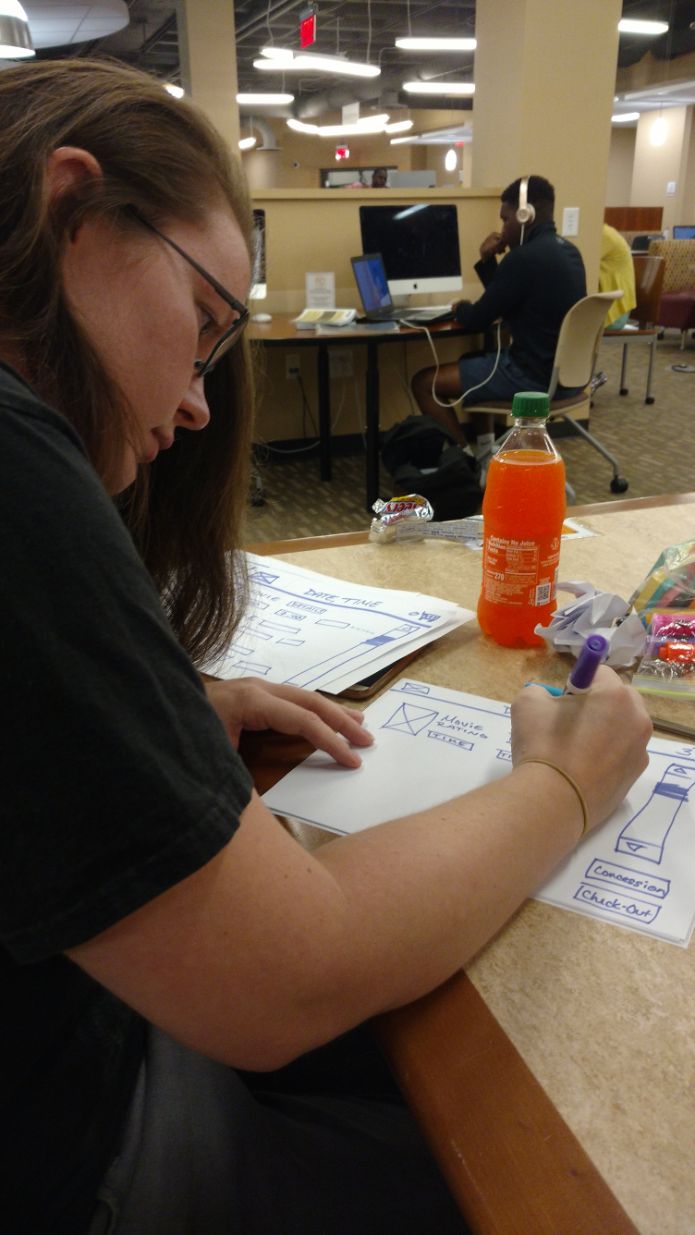 A picture of my teammate drawing up some ideas for our paper prototype before we collaborated on our final paper prototype