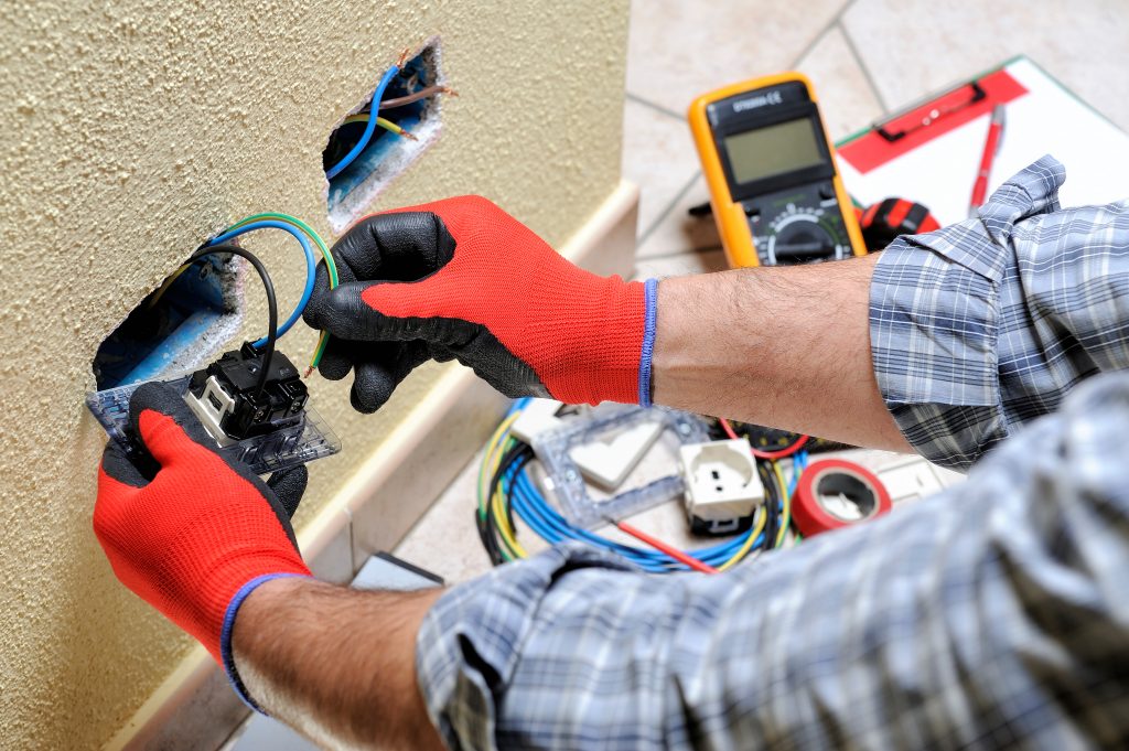 A man working on electrical components in a house